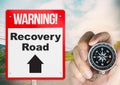 Recovery Road concept sign with holding compass