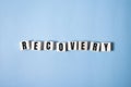 RECOVERY word concept written on wooden cubes lying on a light table and light background.