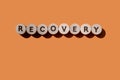 Recovery word from wooden letters on an orange background. Banner. Copy space Royalty Free Stock Photo