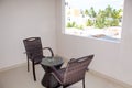 Recreation area on a balcony in hotel a table and chairs overlooking a tropical look