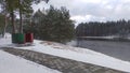 In the recreation area on the sandy shore of the lake near the pine forest, a changing cabin made of thin sheet metal was installe