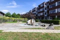 A recreation area with a stone fountain next to a residential building. Royalty Free Stock Photo