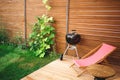 Recreation area in the yard of the house: chairs, barbecue, table