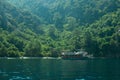 Recreation on the boat near the shore of a mountain and forest. beautiful lagoon. ship in the bay. summer vacation Royalty Free Stock Photo