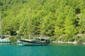 Recreation on the boat near the shore of a mountain and forest. Ship in the bay. summer vacation travelling Royalty Free Stock Photo