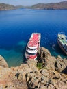 Recreation on the boat near the shore of a mountain. Ship in the bay with swimming people. summer vacation travelling Royalty Free Stock Photo