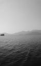 Recreation on the boat near the shore of a mountain. Ship on the water. summer vacation. black and white Royalty Free Stock Photo