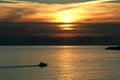 Recreation boat sailing at sunset