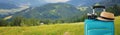 Recreation image of traveler luggage, camera and fedora hat in front of a rural landscape. holiday and vacation concept. banner