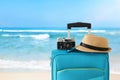 Recreation image of traveler luggage, camera and fedora hat infront of tropical background. holiday and vacation concept Royalty Free Stock Photo