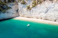 Recreation small boat in beautiful gulf with turquoise water. Faraglioni sea stacks in Puglia, Baia delle Zagare Royalty Free Stock Photo