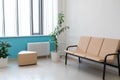 Recreation and waiting area in the corridor of the hospital, clinic, large office building. Beige sofa, a green plant Royalty Free Stock Photo