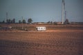 Recreational camper van in a vast open field at sunset