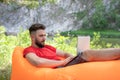 Recreational entrepreneur. Young man with laptop outdoor. Bearder guy hipster working with laptop at campsite Royalty Free Stock Photo