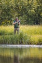 Recreational fisherman at river bank Royalty Free Stock Photo