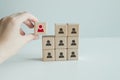 Recruiter complete team by one leader person, professional staff research, hand hold red people icon on cube. Royalty Free Stock Photo