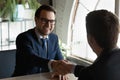 Recruiter hr manager shaking excited candidate hand at job interview