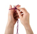 Recruitment process loops for knitting. Female hands knitting with spokes of woolen thread isolated on white background Royalty Free Stock Photo