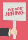 Recruitment shoutout with a placard banner against a red background. Concept of job vacancy, corporate recruitment or career