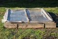 Rectangle homemade makeshift small greenhouse used to grow organic lettuce in part of local home urban garden Royalty Free Stock Photo