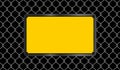 Rectangle sign yellow on wire mesh black background, caution emblem on fence barb grid, copy space, empty warning sign template on Royalty Free Stock Photo