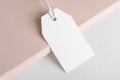 Rectangle white tag mockup on a beige background with cotton string, element for design