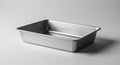 Rectangular aluminum baking pan with rounded edges on a white surface Royalty Free Stock Photo