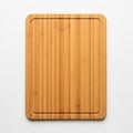 Rectangular bamboo cutting board with rounded corners on a white Royalty Free Stock Photo
