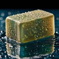 Rectangular bar of soap, olive-green in color, with water droplets on the surface, creating a glistening effect Royalty Free Stock Photo