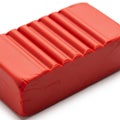 Red Bar Of Modeling Clay With Parallel Grooves On A White Background plasticine crimson Royalty Free Stock Photo