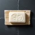 A rectangular bar of white soap with an ornate swirl pattern on its surface rests on Royalty Free Stock Photo