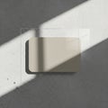 Rectangular beige card with rounded corners rests on a textured gray concrete surfa Royalty Free Stock Photo