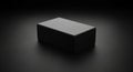 Rectangular black box centered on a dark background. The box has smooth surfaces Royalty Free Stock Photo