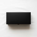 Rectangular black box with a matte finish rests on a white fabric surface Royalty Free Stock Photo