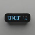 Rectangular black case displaying time in bright blue numerals Royalty Free Stock Photo