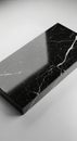 Rectangular block of polished black marble with white veining patterns. It rests on a Royalty Free Stock Photo