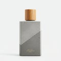 Rectangular bottle with a matte concrete finish and geometric design. The cap is Royalty Free Stock Photo