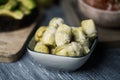 Rectangular bowl with cooked artichoke hearts