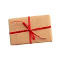 Rectangular box wrapped in brown paper and tied with a red bow, gift isolated on white background, template for designer,  great Royalty Free Stock Photo