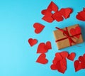 A rectangular box is wrapped in brown paper and tied with a red thin silk ribbon Royalty Free Stock Photo