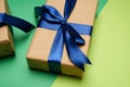Rectangular box wrapped in brown paper and tied with a silk blue ribbon with a bow Royalty Free Stock Photo