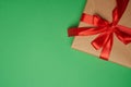 Rectangular box wrapped in brown paper and tied with a silk red ribbon with a bow Royalty Free Stock Photo