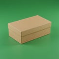 Rectangular cardboard box with a lid, placed against a solid green background. The Royalty Free Stock Photo