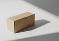 Rectangular cardboard box on a smooth, white surface. Positioned t Royalty Free Stock Photo