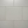 Rectangular ceramic tiles with a smooth, glossy surface and light gray color are arranged in a Royalty Free Stock Photo