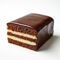 Rectangular chocolate opera cake slice sits on white background. Layers of moist cake and rich cream frosting are visible. Shiny Royalty Free Stock Photo