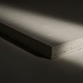 Rectangular concrete block displayed dramatically under a beam of light, casting Royalty Free Stock Photo