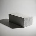 Rectangular concrete block resting on a plain surface with a light gray Royalty Free Stock Photo