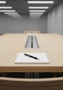 Rectangular conference room with wood-grain table featuring a central power strip. A Royalty Free Stock Photo