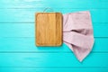 Rectangular cutting board and tablecloth in polka dots on blue wooden background. Top view and copy space. Royalty Free Stock Photo